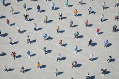 Crowd of people socially distanced with chalk lines connecting them