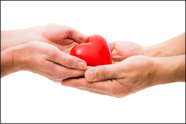 Person giving a heart figure to another person