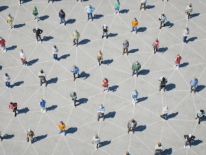 Crowd of people socially distanced with chalk lines connecting them